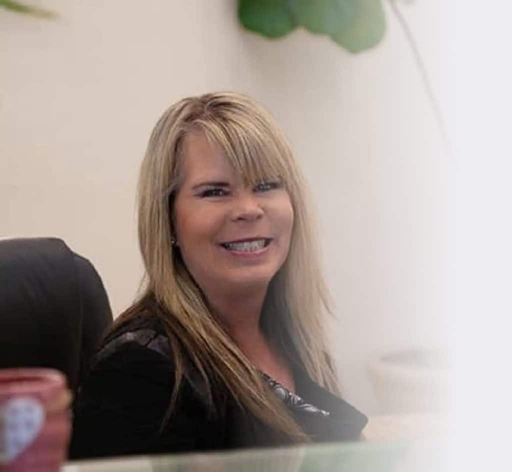 Bethany sitting at her desk smiling