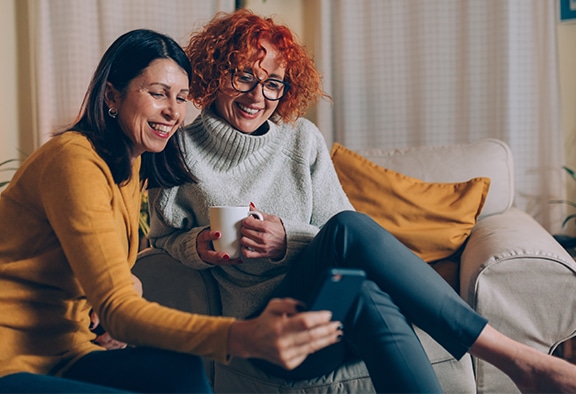 women laughing looking at diabetes hacks