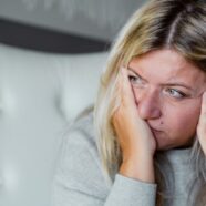 A woman is shown thinking about the connection between diabetes and stress.