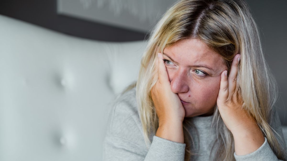 A woman is shown thinking about the connection between diabetes and stress.